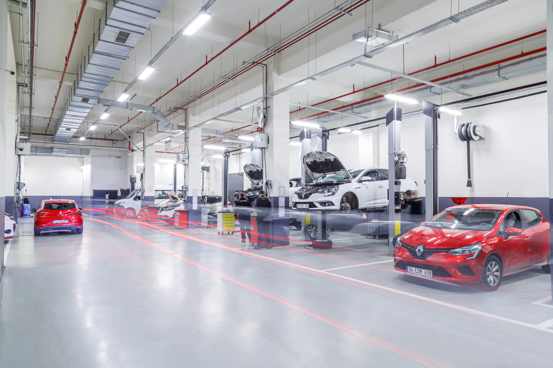 Modern NextGen Auto Experts style service bays with cars on lifts in Toronto