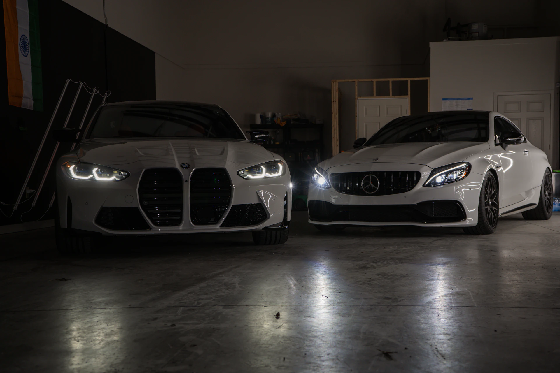BMW M4 and Mercedes-AMG C63 luxury cars in a Toronto auto service garage