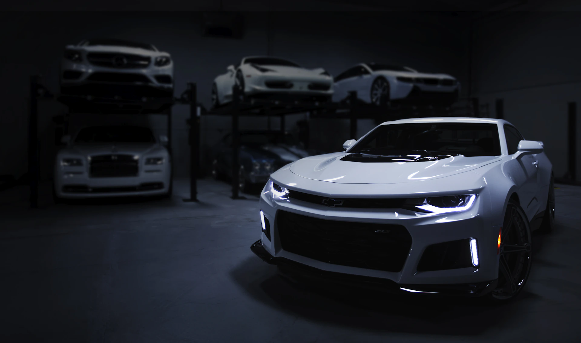 Luxury and exotic sports cars on lifts in a Toronto auto repair shop