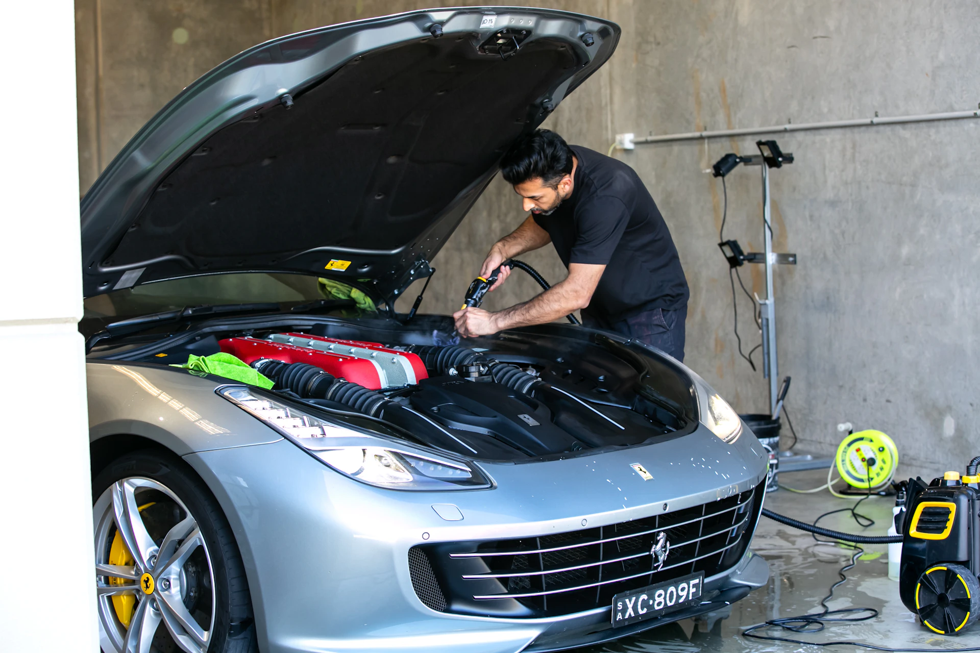 Auto mechanic performing engine repair on a Ferrari V12 in Toronto