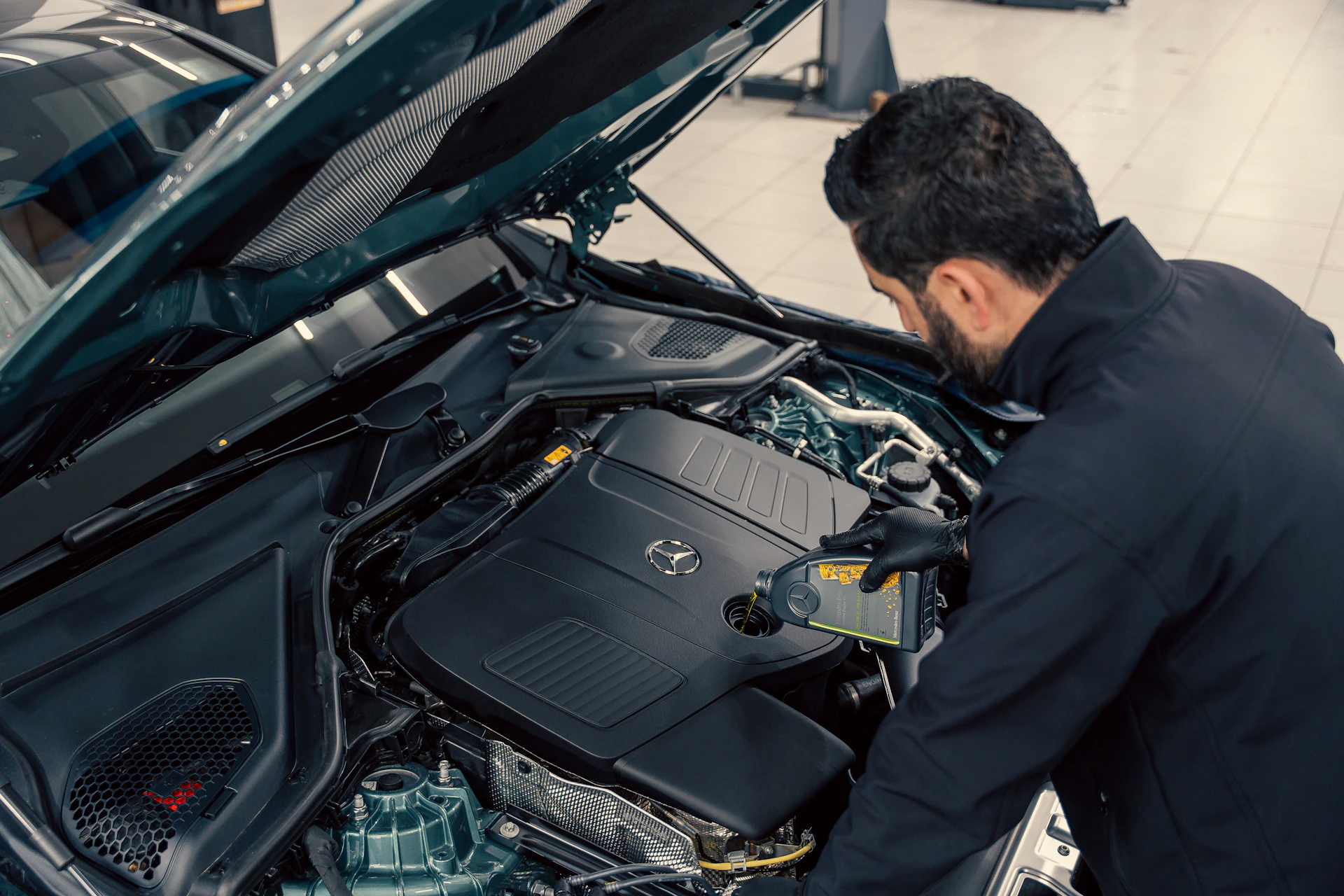 Technician inspecting a Mercedes-Benz engine for European car repair in Toronto