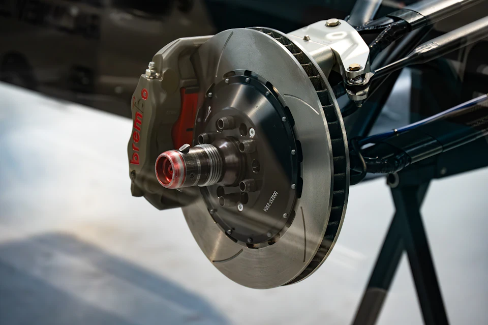 Brake caliper and disc checked during an Ontario safety standards certificate inspection