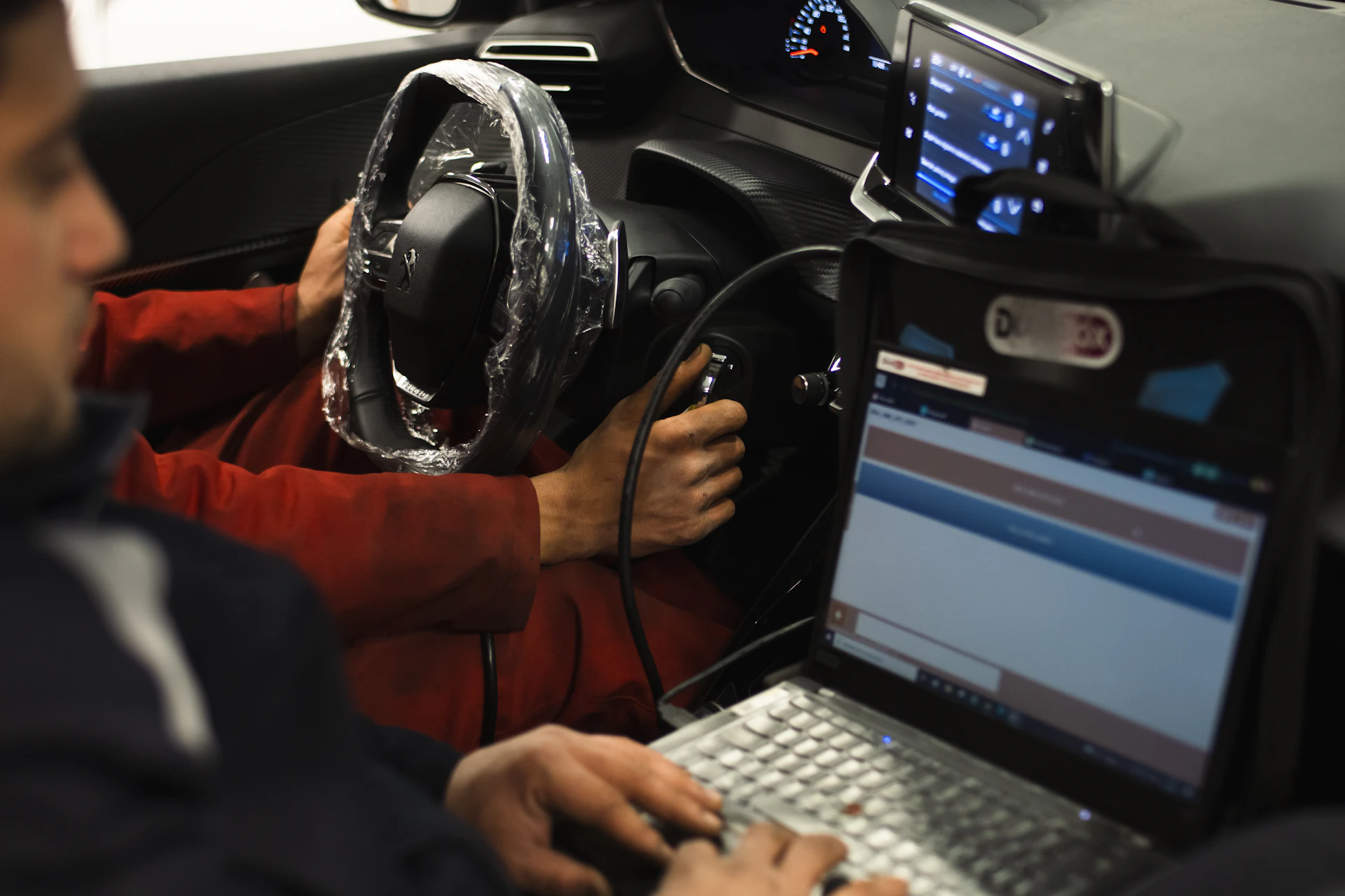 Technician running diagnostics during a vehicle safety inspection in Toronto