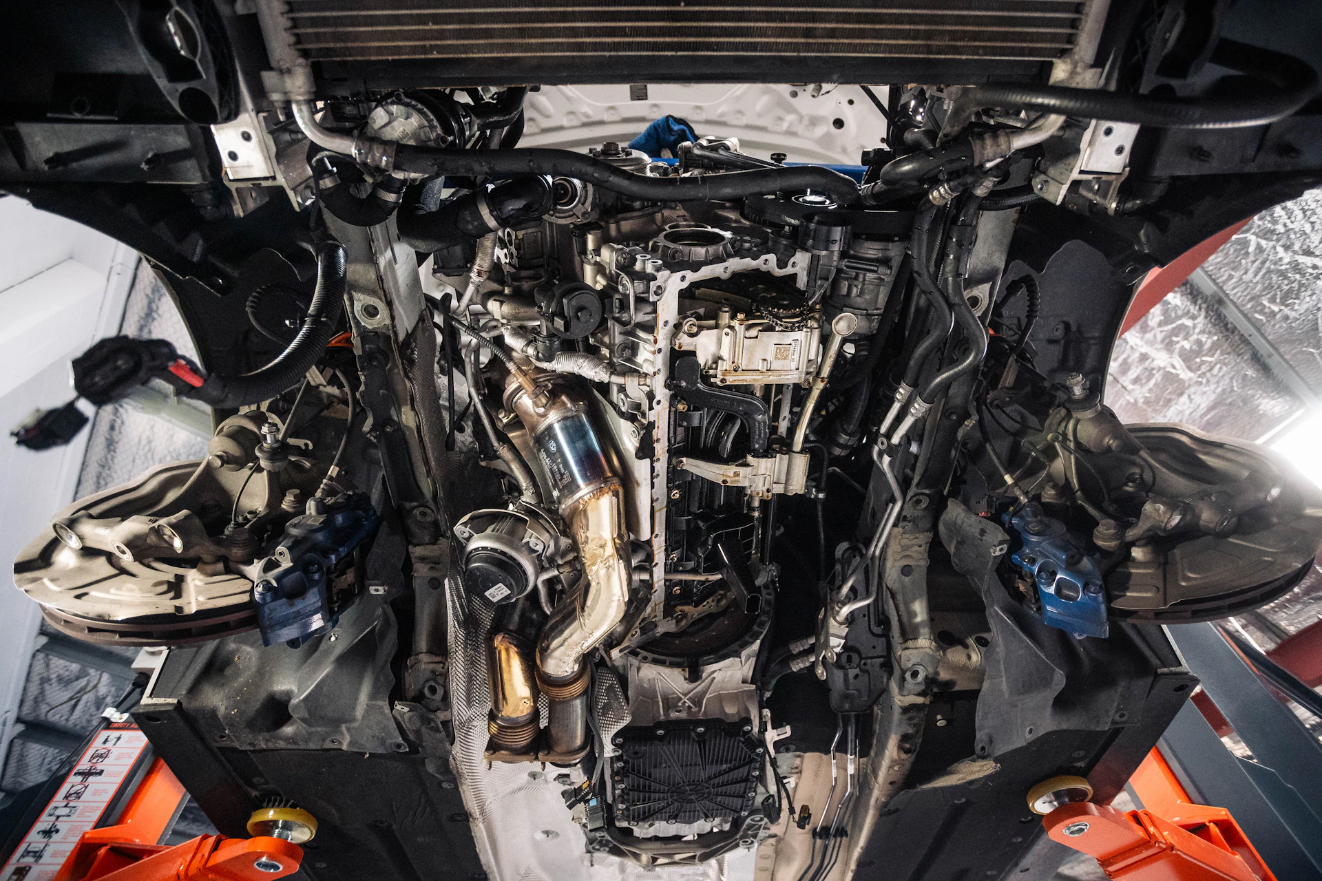Car undercarriage and chassis on a lift during a frame inspection in Toronto