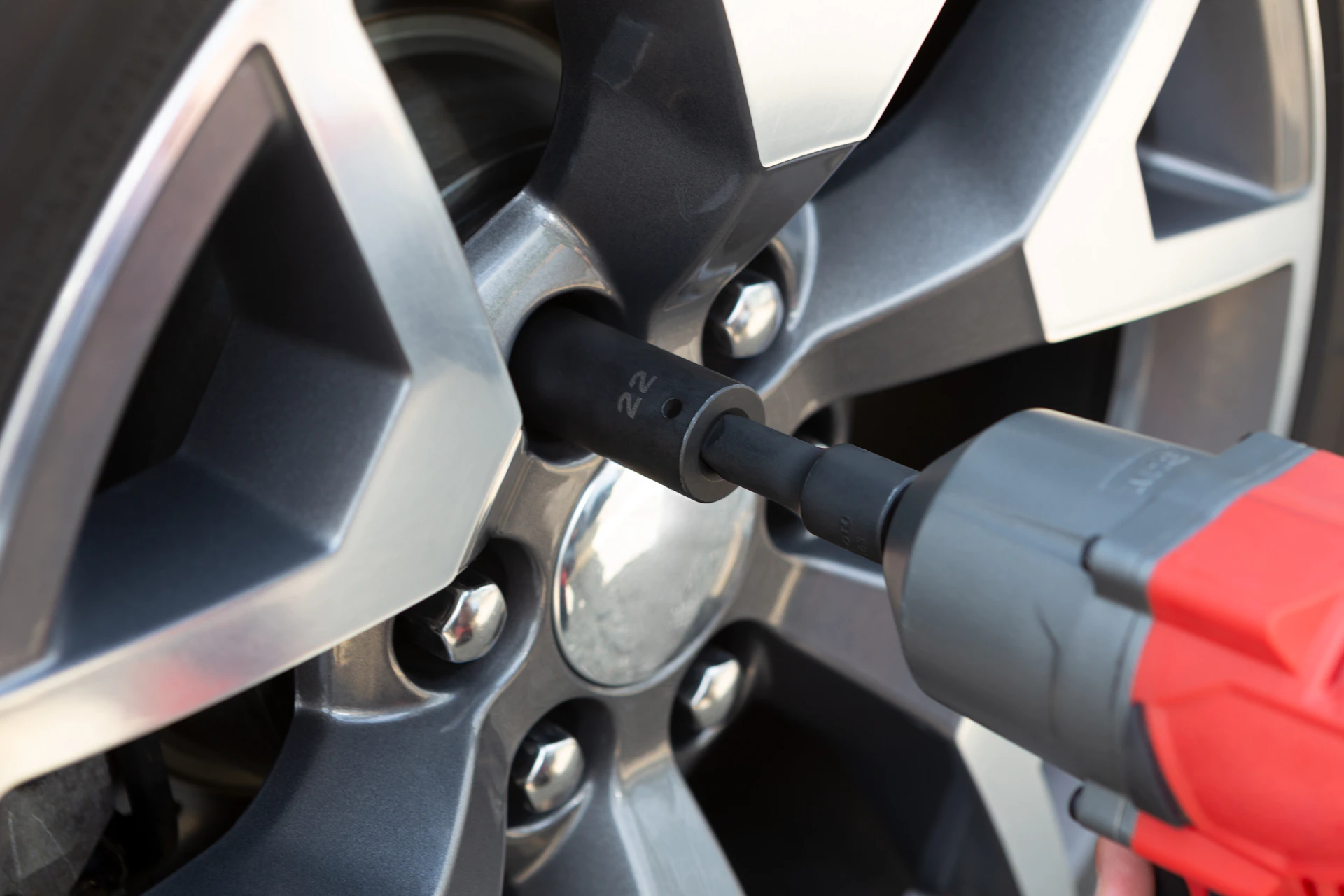 Impact wrench tightening lug nuts during tire installation at a Toronto tire shop