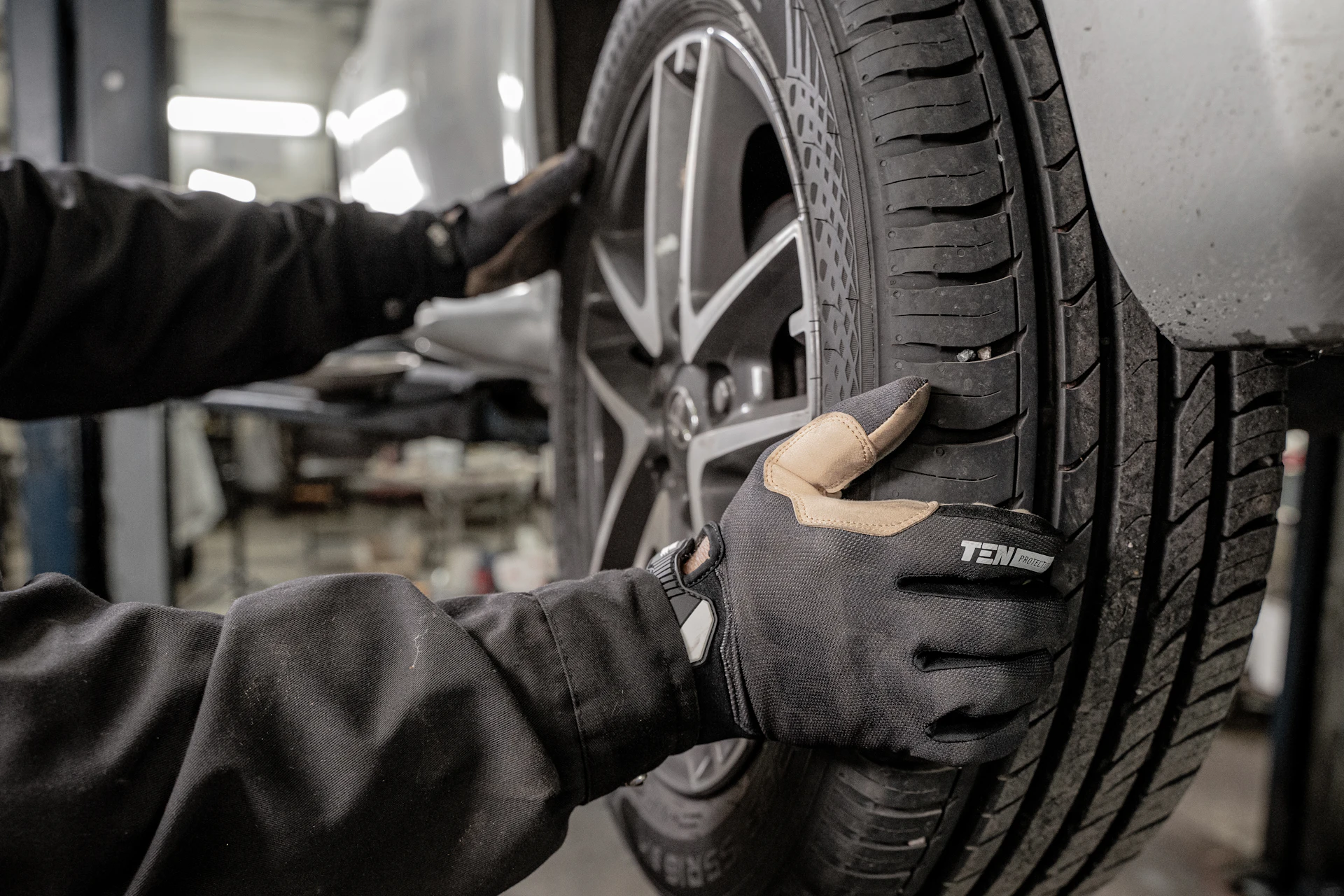 Mechanic mounting a wheel during a seasonal tire change in Toronto